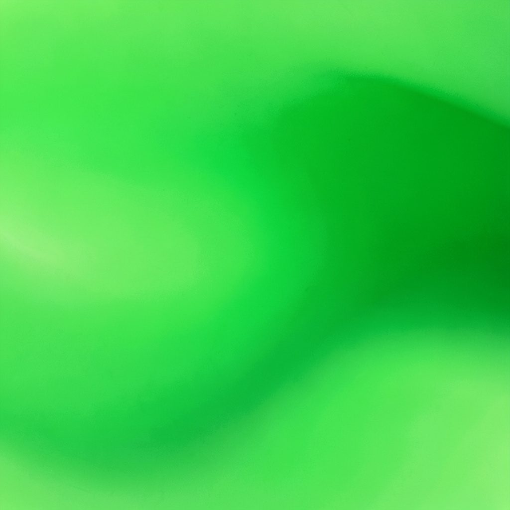 A close-up of a smartphone displaying a loan application interface with a green accent, set against a clean white desk.